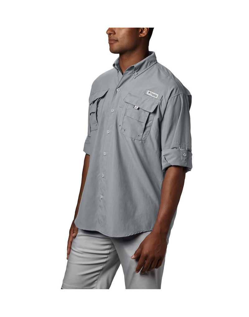 Man wearing Columbia Men's PFG Bahama™ II Long Sleeve Shirt - cool grey, front side view showing sleeves rolled up