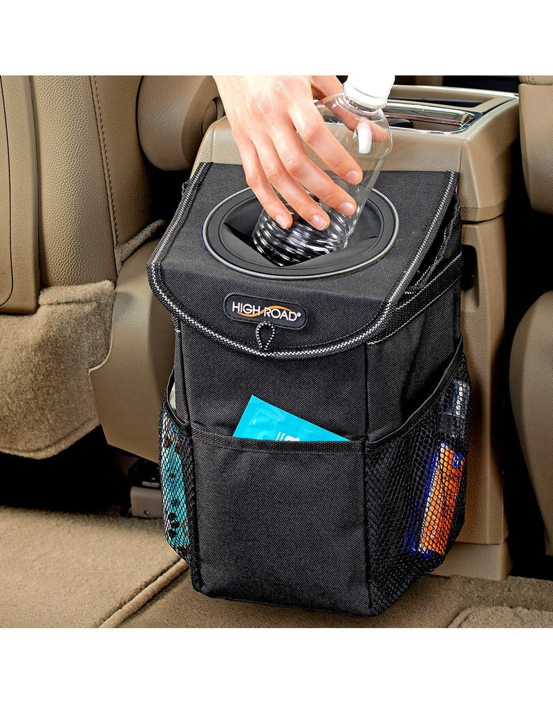 Men throwing garbage in high road stashaway headrest and console car trash can black colour front view