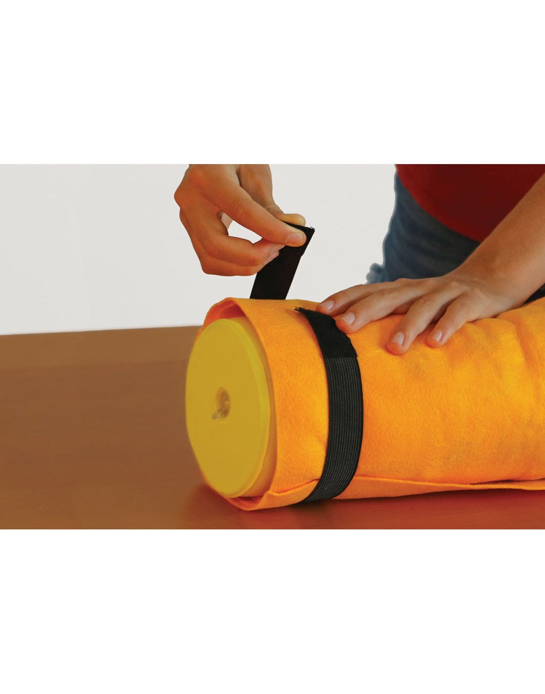 Smart Puzzle Roll & Go Mat - hands securing the Velcro loop carrying strap