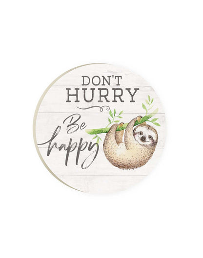 Round car coaster with white wooden slat background and sloth hanging from a green branch with words Don't Hurry Be Happy