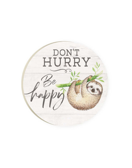 Product Image – Round car coaster with white wooden slat background and sloth hanging from a green branch with words Don't Hurry Be Happy