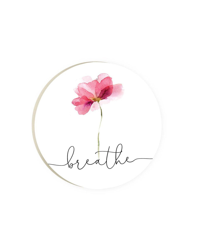 Round car coaster with white background and pink watercolour flower image and words breathe written in black script font beneath