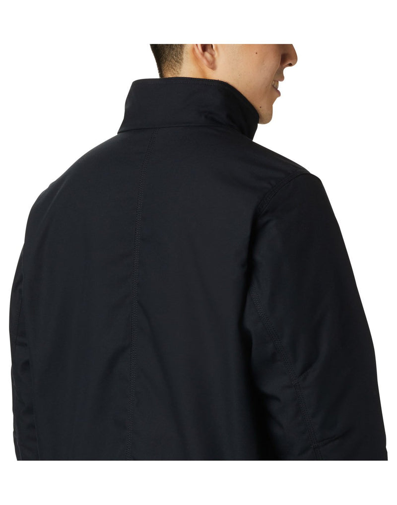 Close up of man wearing black Columbia Men's Loma Vista™ Jacket, zipped up, angled back view
