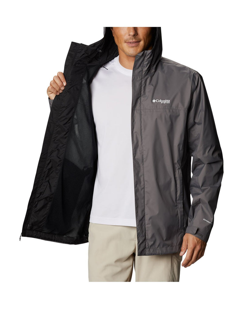 Man wearing Columbia Men's PFG Storm™ Jacket  - city grey, unzipped, holding right side open to show interior of jacket which is black mesh