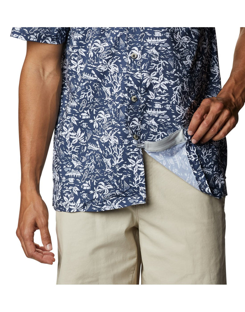 Close up of Columbia Men's PFG Super Slack Tide™ Camp Shirt, hand holding bottom of shirt up to show fabric reverse