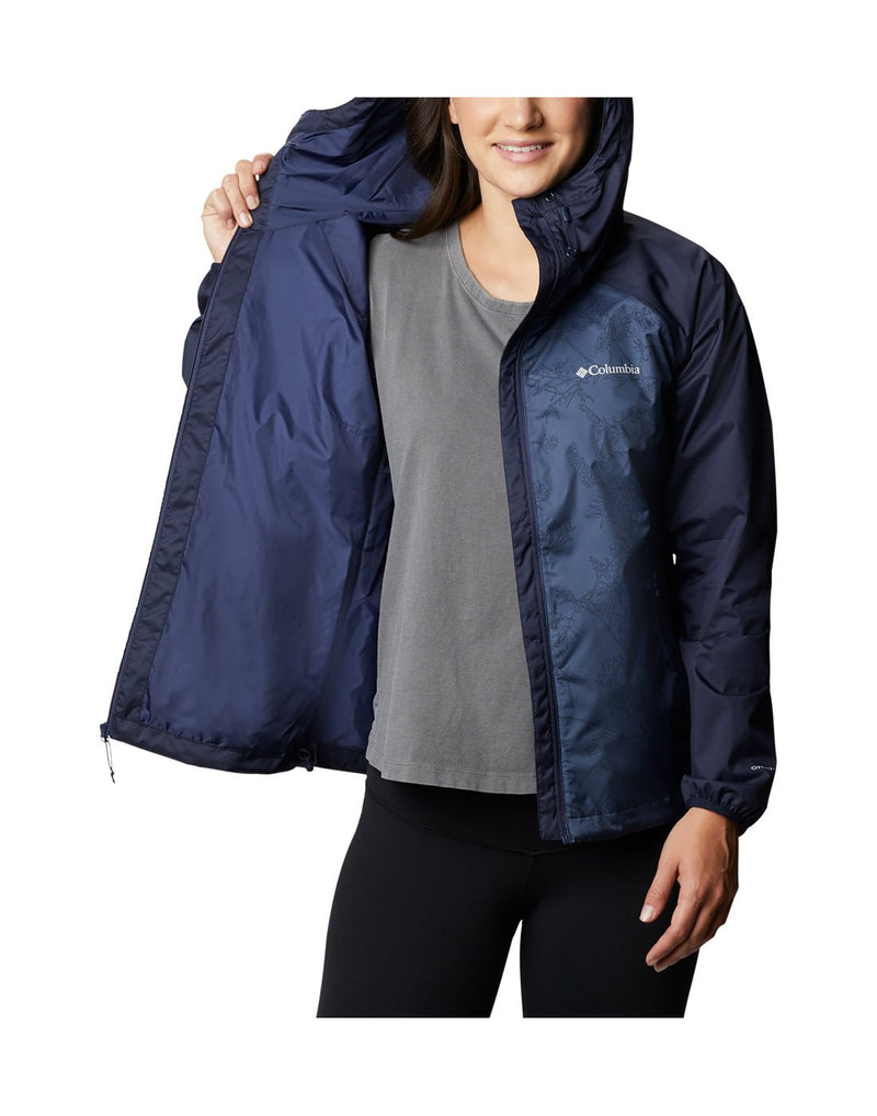 Model wearing Columbia Women's Ulica™ Jacket - nocturnal blue, front view unzipped, held open on one side to show interior