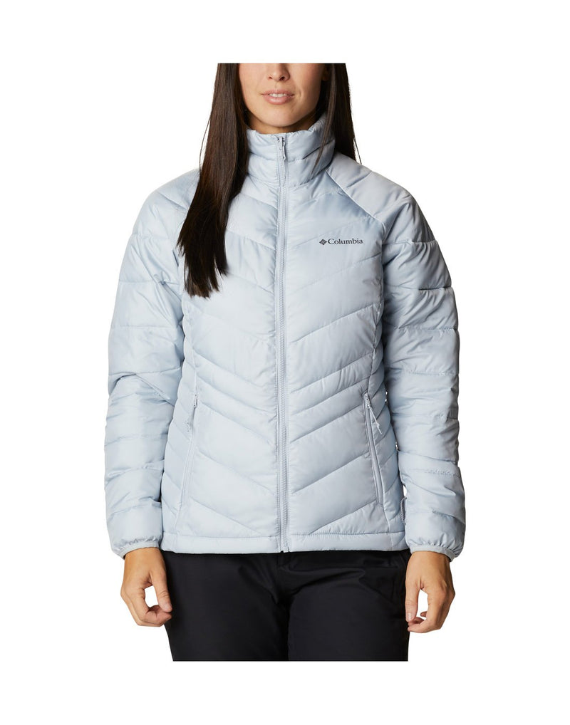 Woman wearing Columbia Women's Whirlibird™ IV Interchange Jacket, shell removed, lighter puff jacket, zipped up, front view