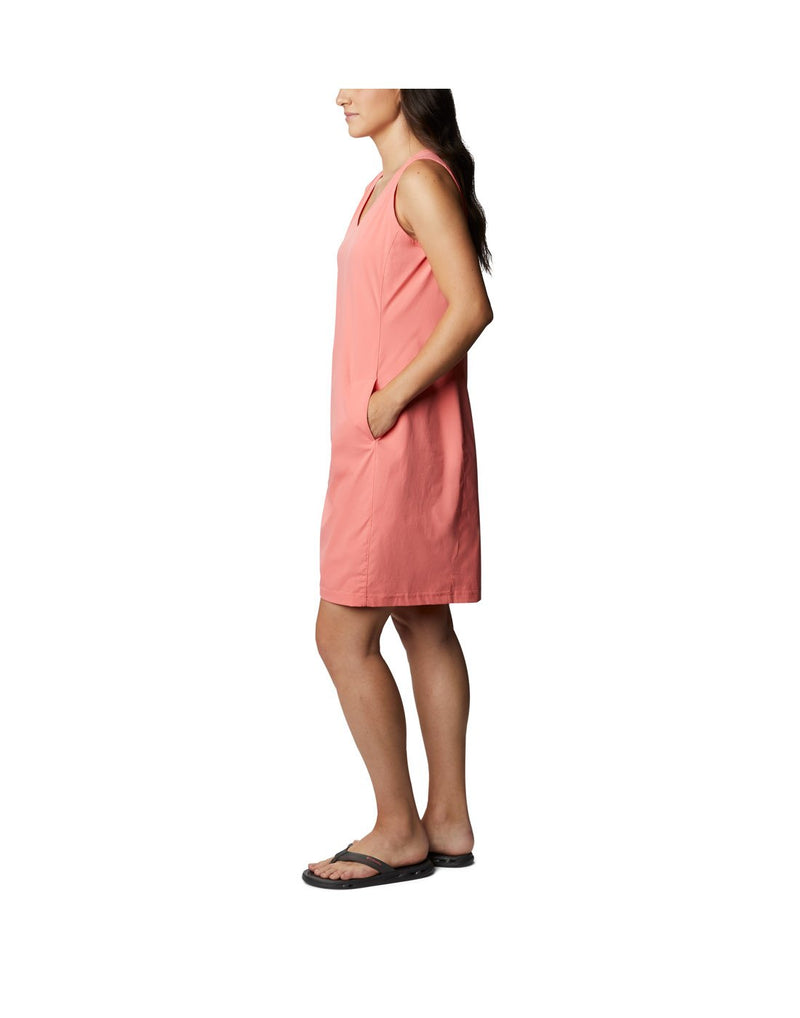 Woman wearing Columbia Women's Anytime Casual™ III Dress - salmon, side view with hand in left pocket