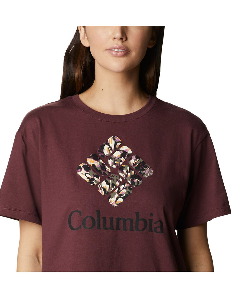Close up of woman wearing Columbia Women's Columbia Park™ Relaxed Tee in malbec colour with oversized Columbia logo, front view