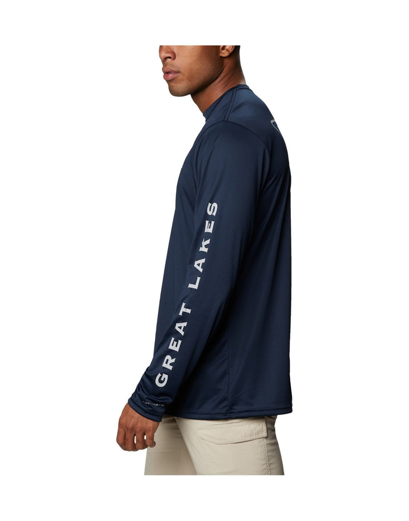 Model wearing Columbia Men's PFG Terminal Tackle™ Destination Long Sleeve Shirt - collegiate navy, side view showing "Great Lakes" along left sleeve