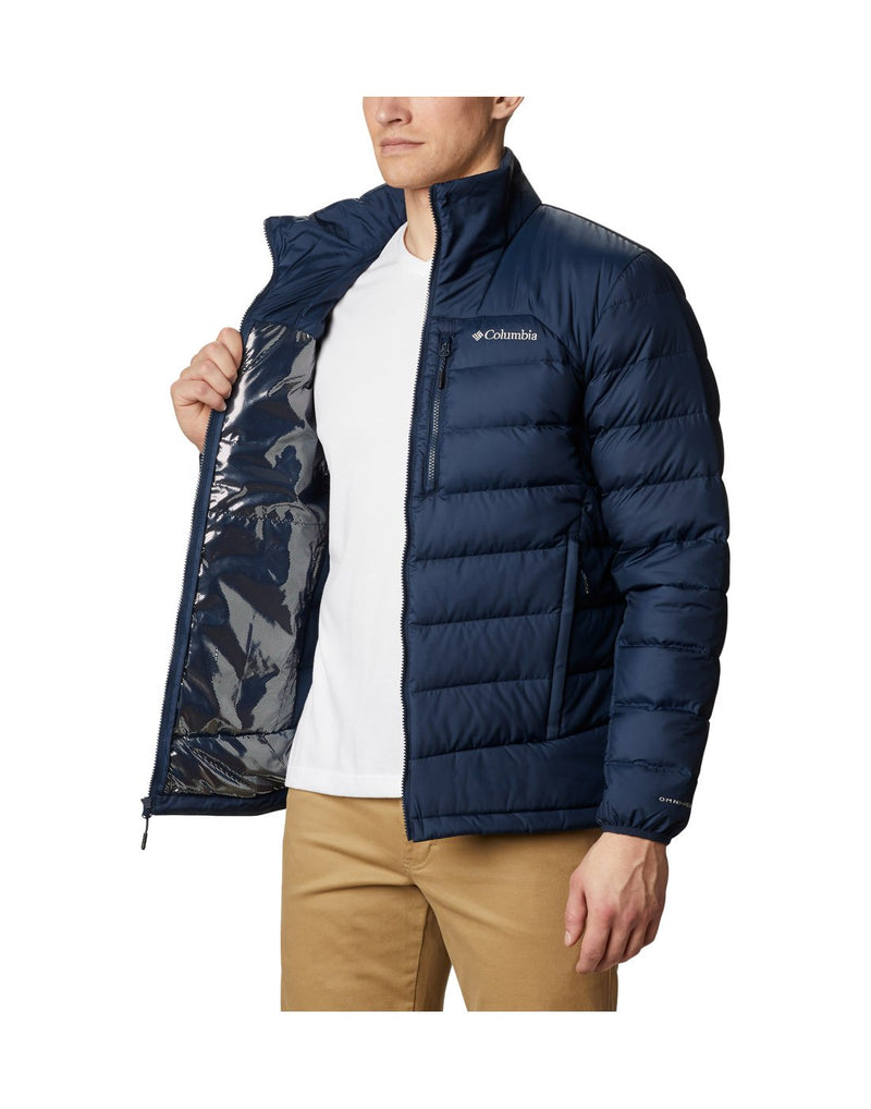 Man wearing Columbia Men's Autumn Park™ Down Jacket in collegiate navy, unzipped, holding one side open to show reflective lining