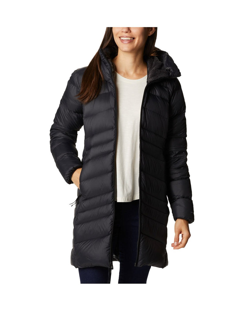 Woman wearing Columbia Women's Autumn Park™ Down Hooded Mid Jacket in black, unzipped with right hand in pocket, front view