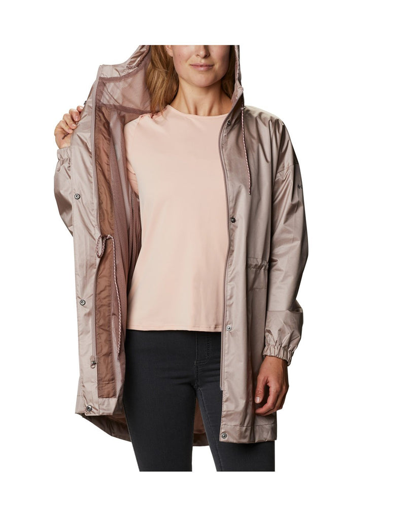 Model wearing Columbia Women's Splash Side™ Jacket - mauve vapor, front view unzipped, held open on one side to show interior