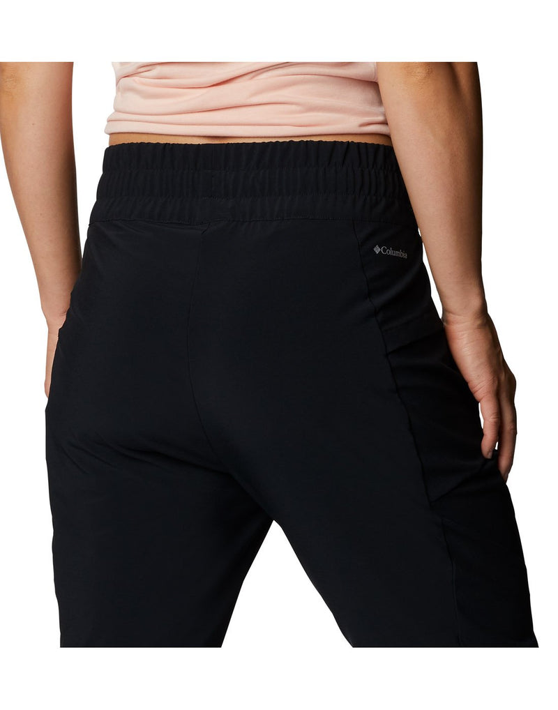 Close up of model wearing Columbia Women's Pleasant Creek™ Convertible Pants - black, back view