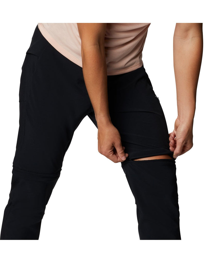 Model demonstrating unzipping pants to convert into shorts