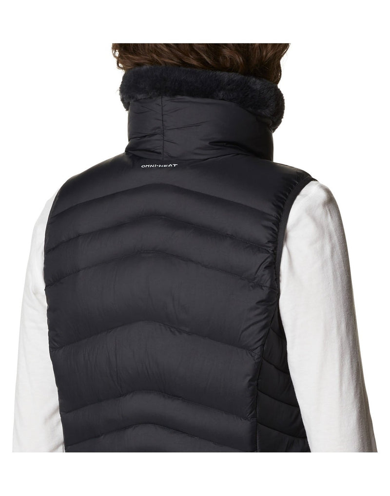 Close up of woman wearing Columbia Women's Autumn Park™ Vest in black, back view, with Omni-heat logo on back of neck