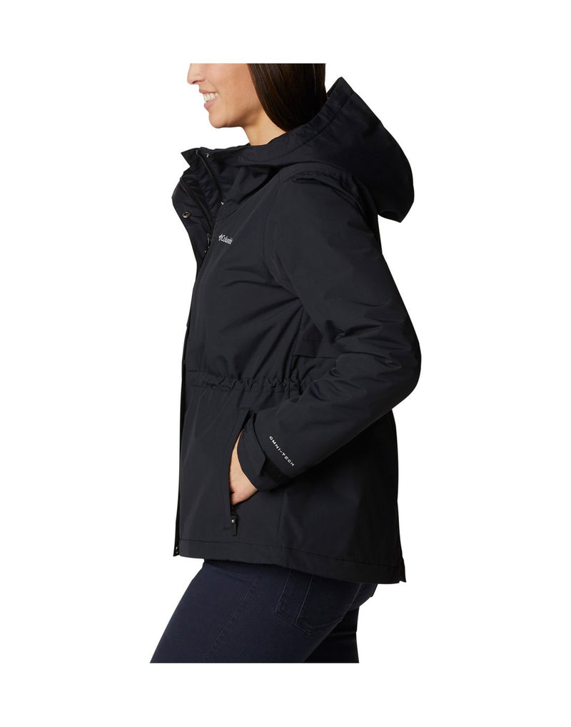 Woman wearing Columbia Women's Hadley Trail™ Jacket in black with hands in pockets, side view