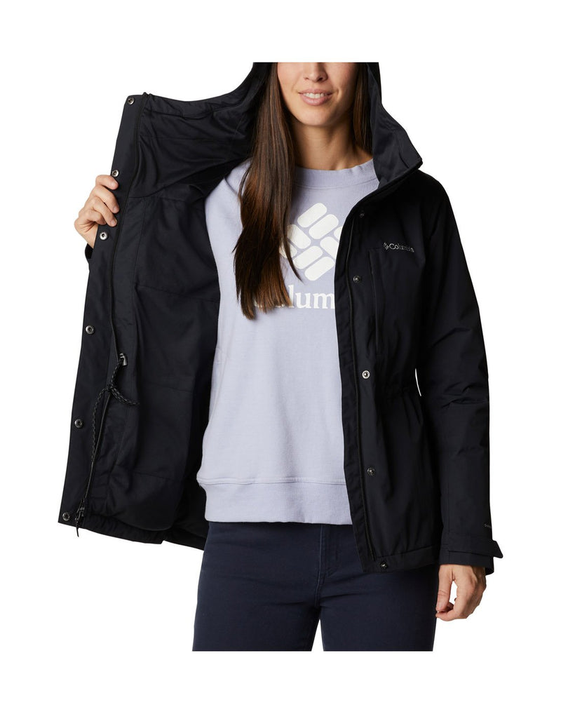 Woman wearing Columbia Women's Hadley Trail™ Jacket in black, unzipped, front view, holding one side open to show interior