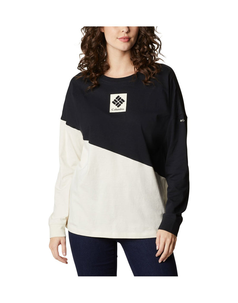Woman wearing Columbia Women's Columbia Park™ Long Sleeve Tee, front view with diagonal line separating top, shoulders and left arm in black and lower chalk part; Columbia logo on centre chest