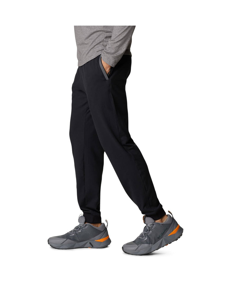 Man wearing Columbia Men's Tech Trail™ Knit Joggers in black, side view with left hand in pocket