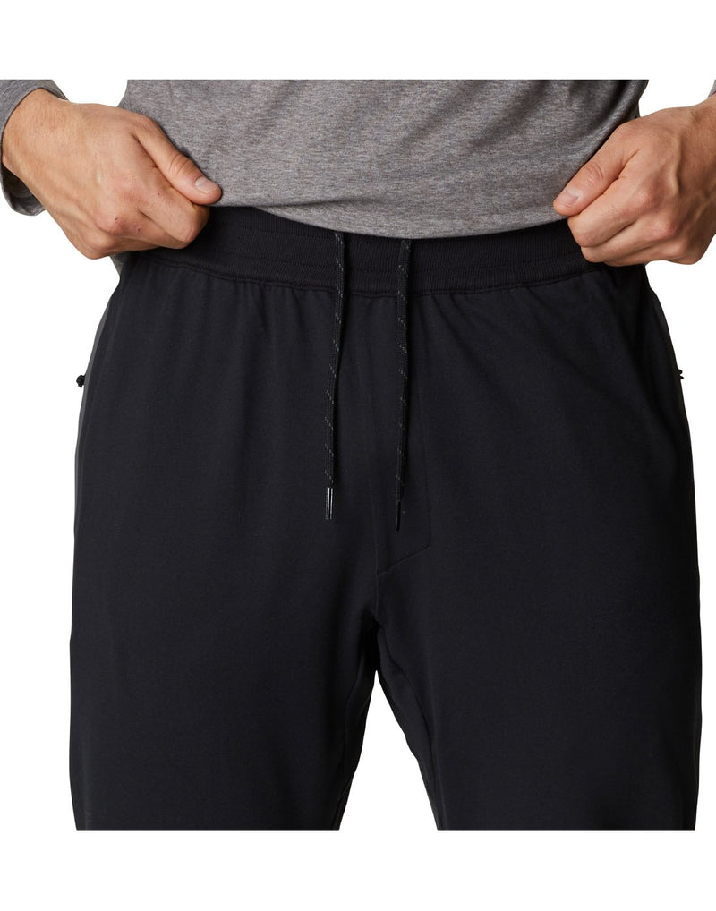 Close up of man wearing Columbia Men's Tech Trail™ Knit Joggers in black, front view showing elastic waistband and drawstrings