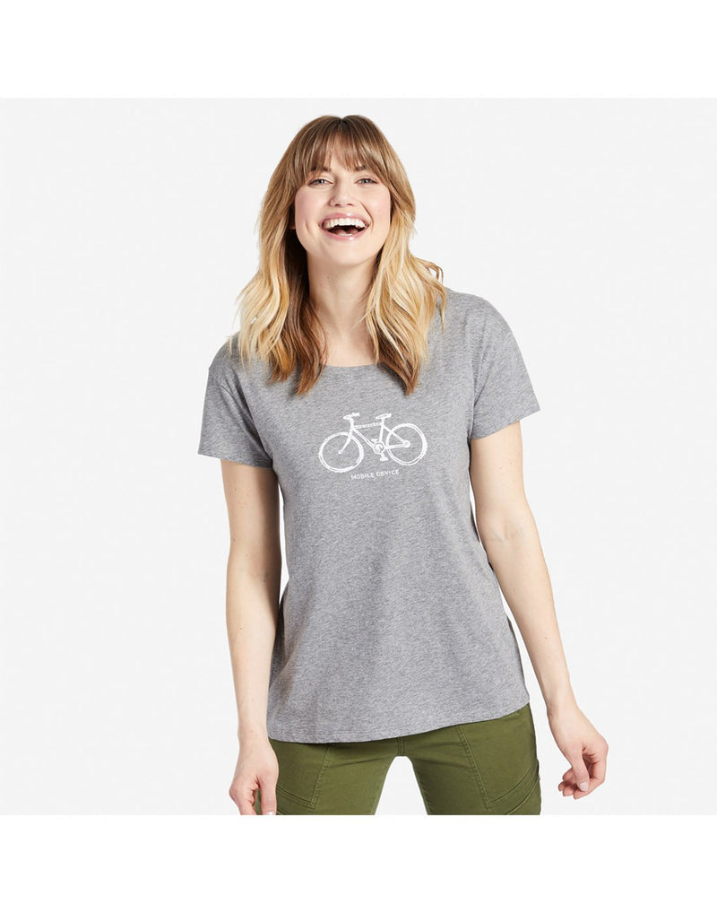 Woman wearing Life is Good Women's Mobile Device Bike Breezy Tee in Heather Grey, front view