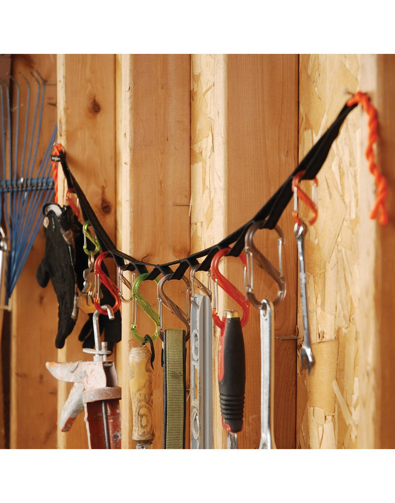 Nite Ize Gearline® Organization System hanging in a shed with various tools and gear attached