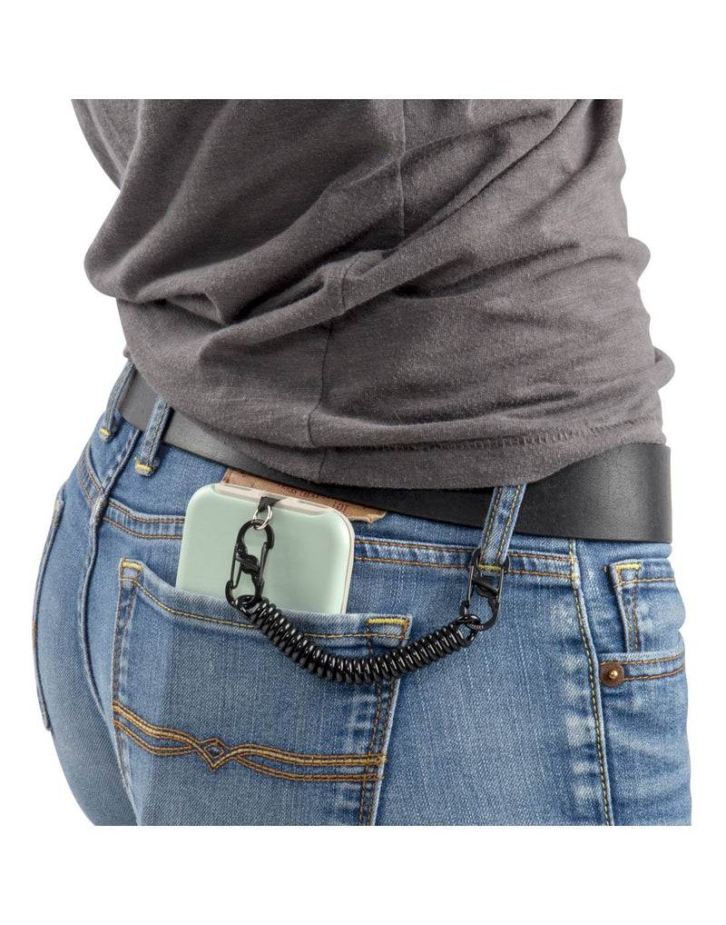 Nite Ize Hitch® Phone Anchor + Tether attached to phone and women's belt loop with phone in her back pocket