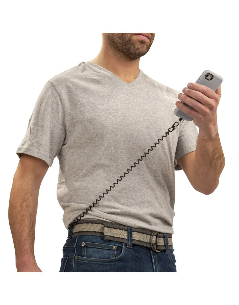 Man holding phone with Nite Ize Hitch® Phone Anchor + Tether attached to belt loop