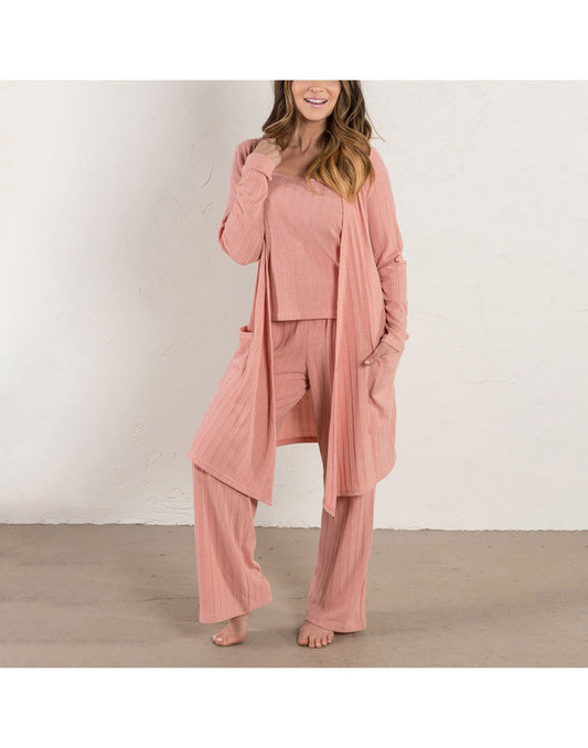 Product Image – Woman wearing Howard's Ribbed Three-Piece Loungewear Set in blush pink colour with one hand in pocket