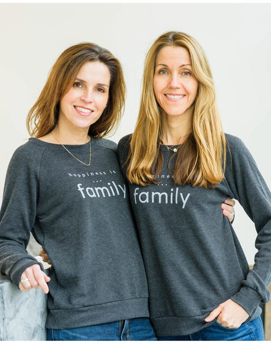 Product Image – Two women wearing blue jeans and Happiness Is...Family Women's Crew Sweatshirts in charcoal standing arm in arm