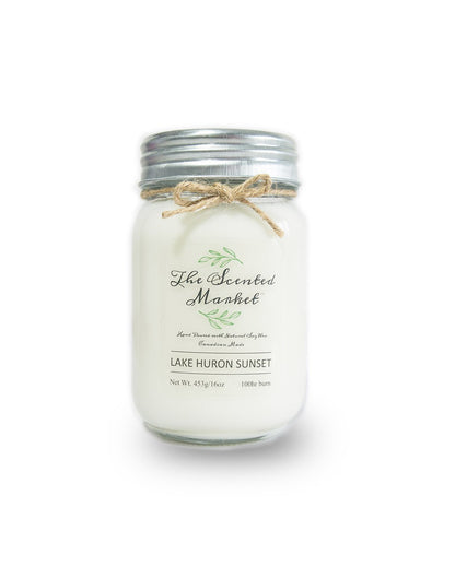 The Scented Market Lake Huron Sunset 16oz Soy Wax Candle front view in a glass jar with metal lid and tied with a twine bow