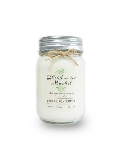 Product Image – The Scented Market Lake Huron Sunset 16oz Soy Wax Candle front view in a glass jar with metal lid and tied with a twine bow