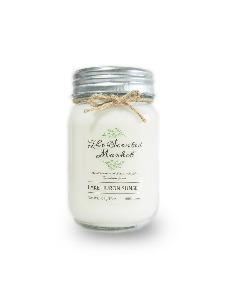 The Scented Market Lake Huron Sunset 16oz Soy Wax Candle front view in a glass jar with metal lid and tied with a twine bow
