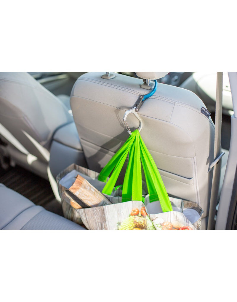 Grocery bags cliped to the medium Heroclip attached to the back of passenger headrest in the back seat of a vehicle