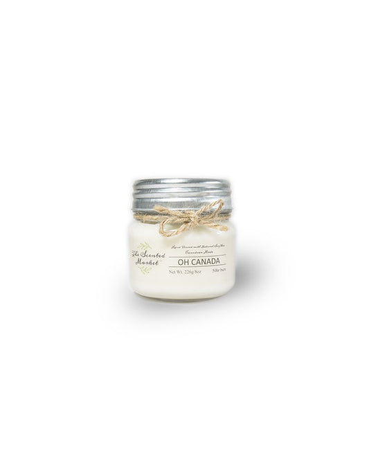 Product Image – The Scented Market Oh Canada 8oz Soy Wax Candle front view in a glass jar with metal lid and tied with a twine bow