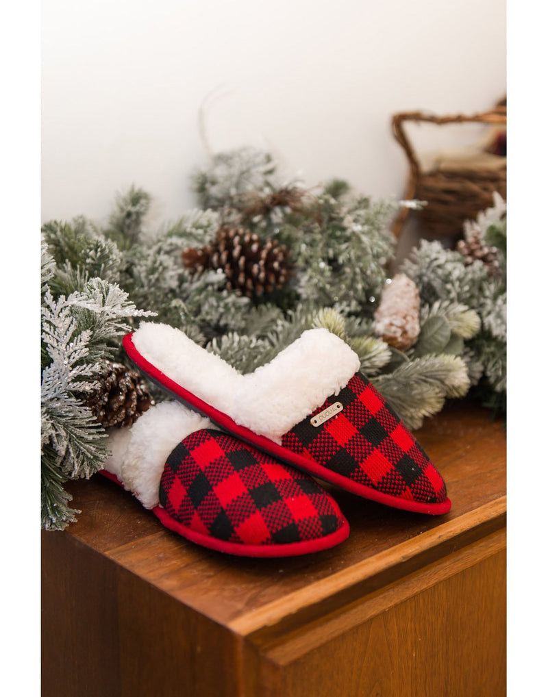 Pudus Creekside Slide Slippers in Lumberjack Red on a wooden mantle with garland beside