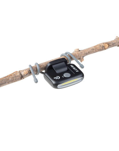 Nite Ize Radiant® 170 Rechargeable Task Light secured to branch with attached gear ties