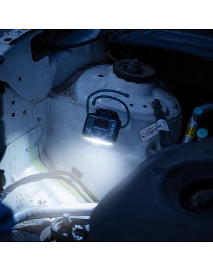 Nite Ize Radiant® 170 Rechargeable Task Light attached to engine shining light on task