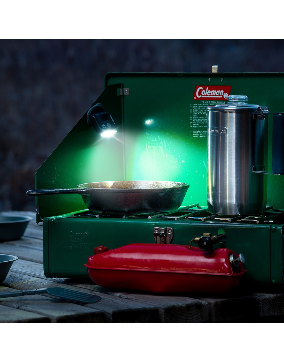 Nite Ize Radiant® 170 Rechargeable Task Light attached with magnet to side of camp stove in low lighting