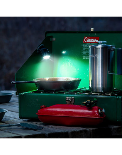 Nite Ize Radiant® 170 Rechargeable Task Light attached with magnet to side of camp stove in low lighting