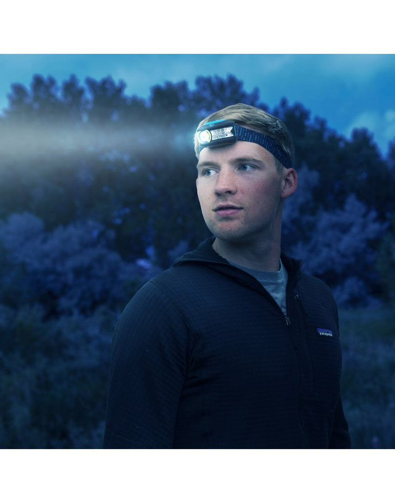 Man using radiant® 300 rechargeable headlamp in low sopt