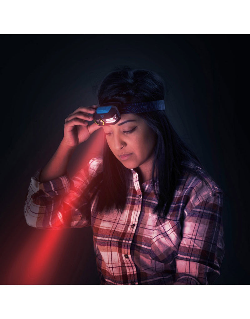 Girl using red LED radiant® 300 rechargeable headlamp 