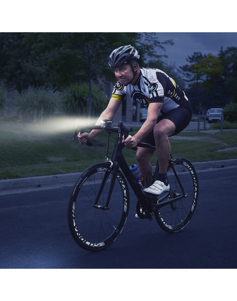 Man using radiant® 750 rechargeable bike light at night