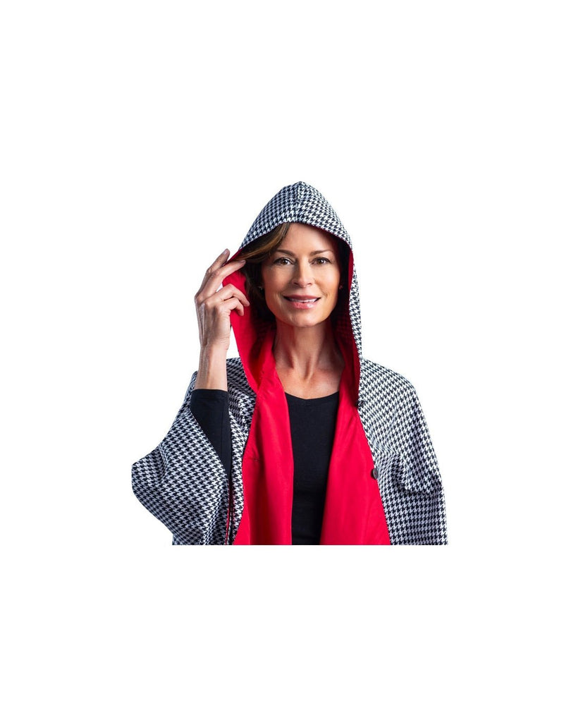 Women wearing RainCaper hooded travel cape - crimson/black & white houndstooth colour 