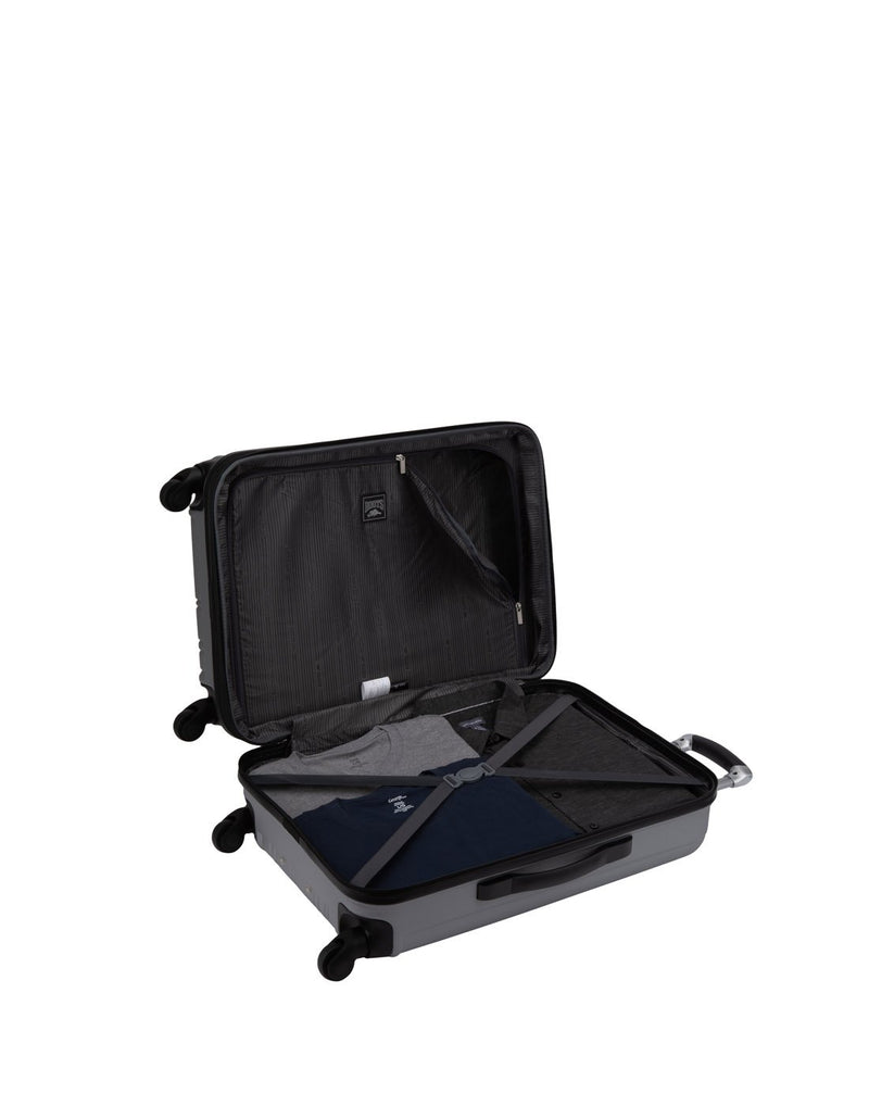 Roots Identity Hardside 24" Expandable Spinner open view with clothes packed inside with tie down straps across one half and a zippered partition on the other side