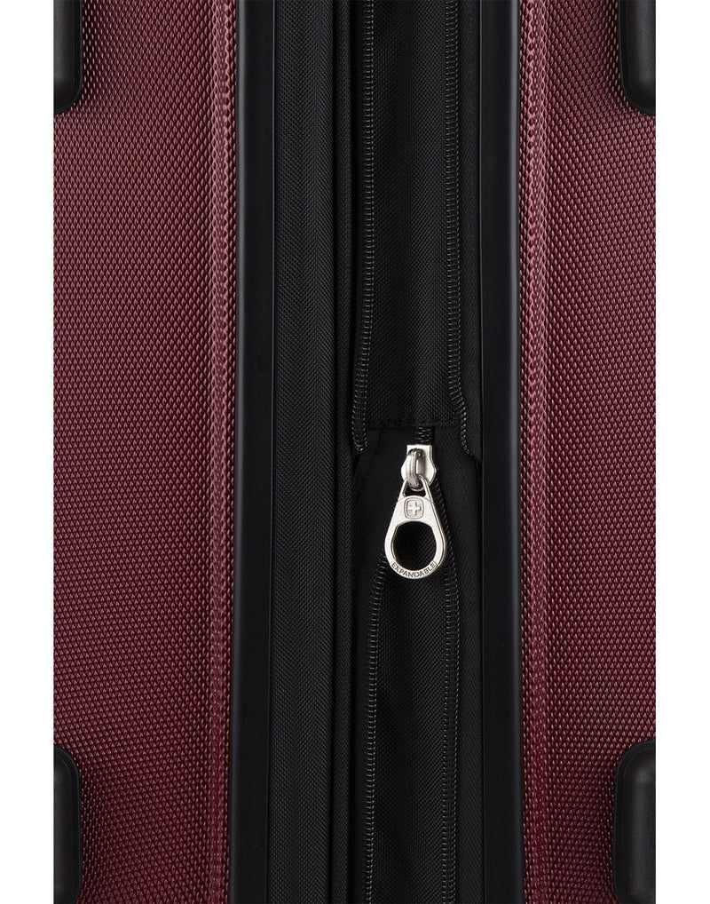 Close up of oxblood colour luggage expandable zipper
