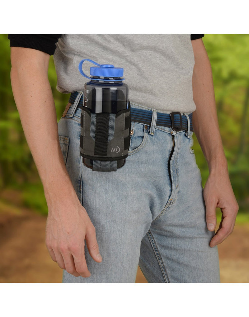 Man using Nite ize traveler™ drink holster with bottle attached to belt