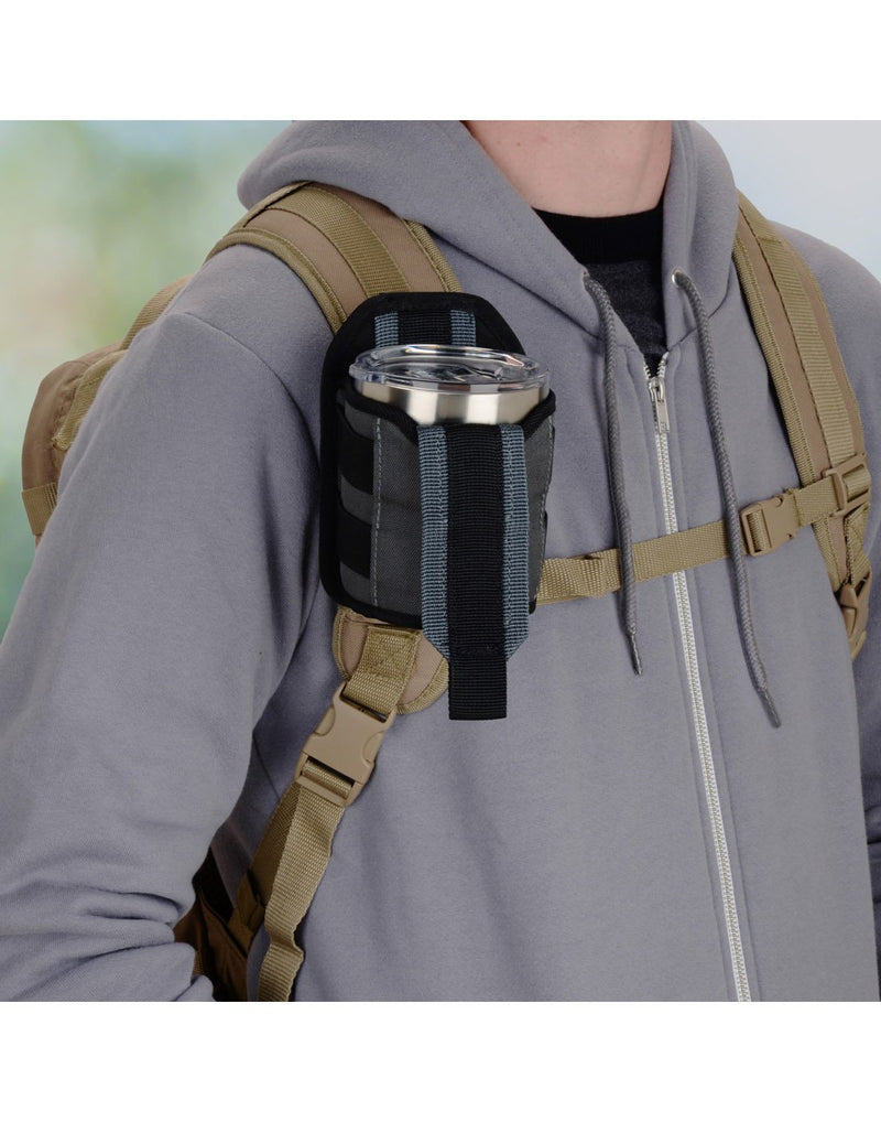Man using Nite ize traveler™ drink holster attached to bag