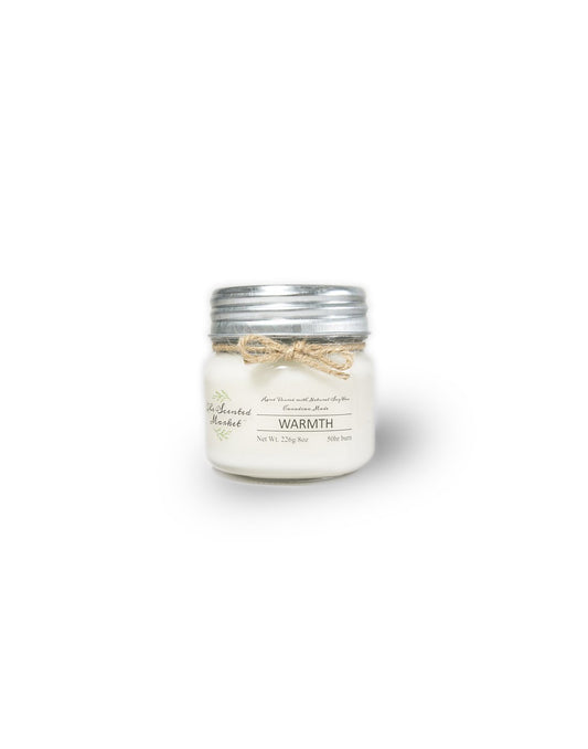 Product Image – The Scented Market Warmth 8oz Soy Wax Candle front view in a glass jar with metal lid and tied with a twine bow